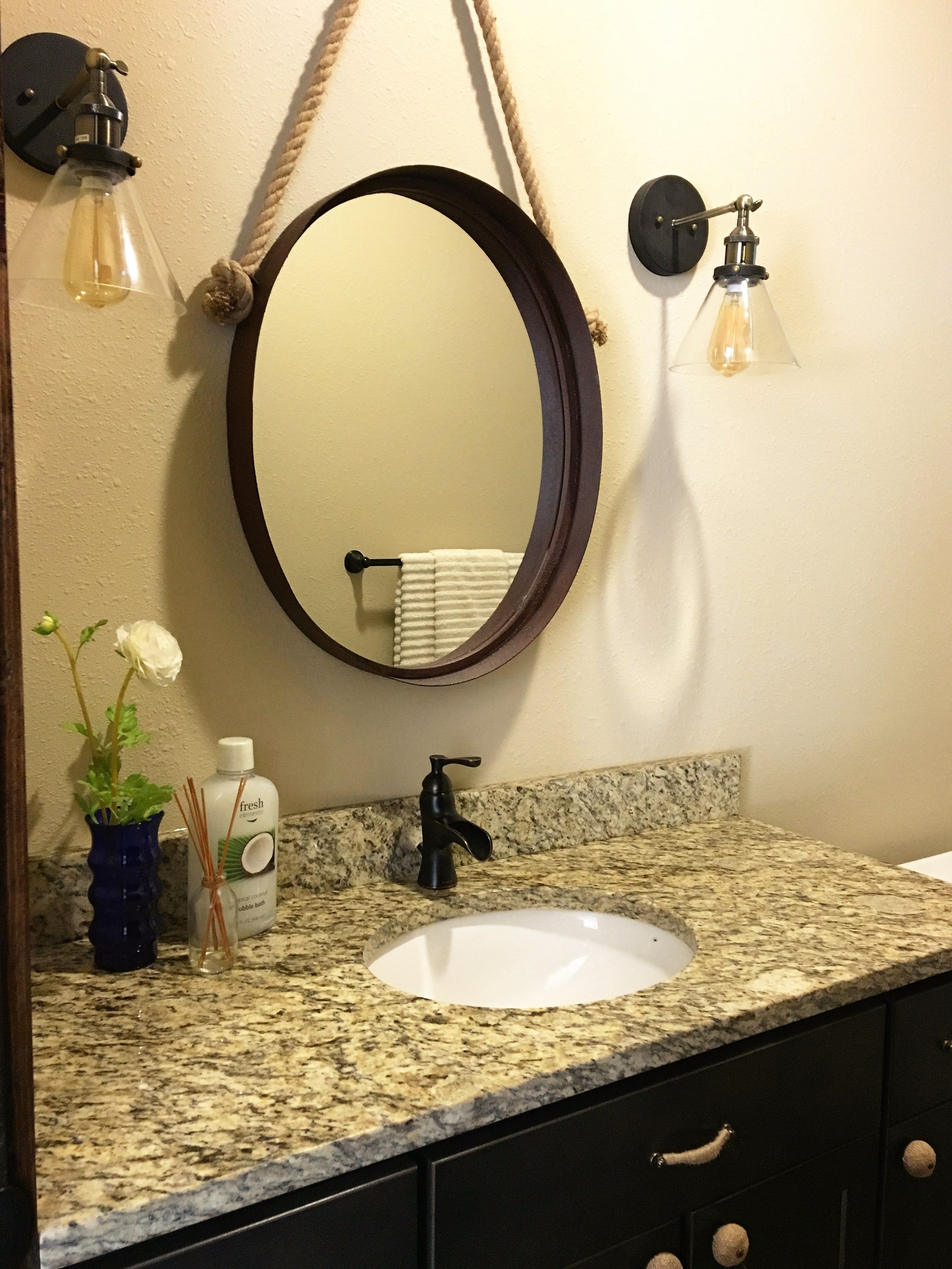 Unique mirror and sconce combo to customize this bathroom. | Mirror and