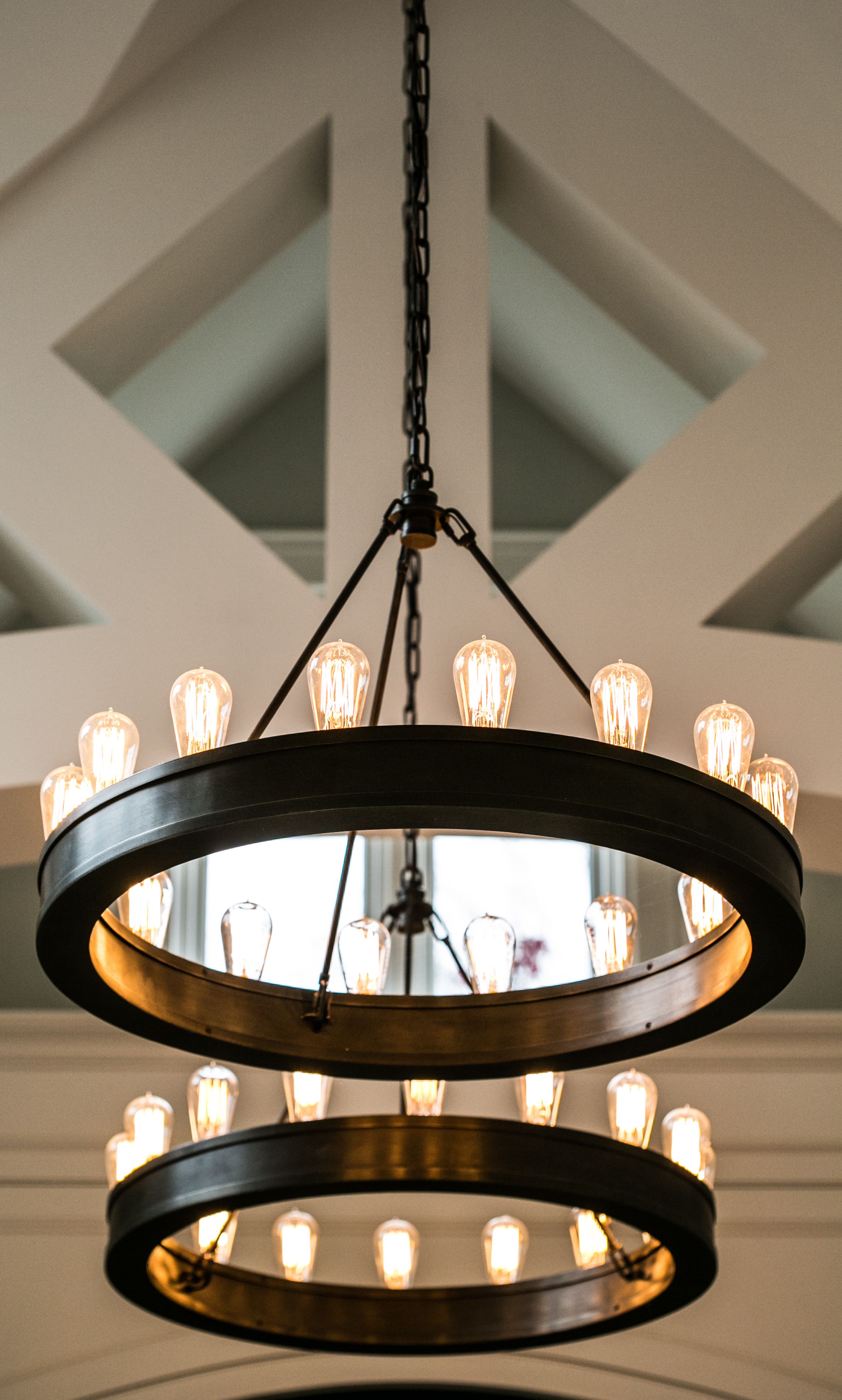 Basement bar with wood paneling and hanging pendant lights.